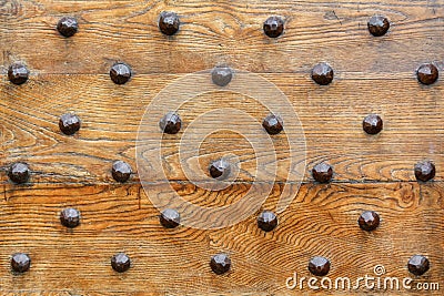 Iron rivets on a wood front door Stock Photo