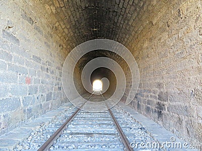 iron road bridges metal rail light at the end of the tunnel train transport Stock Photo