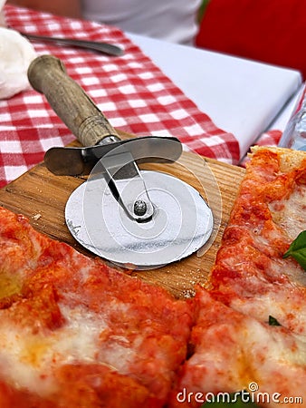 Iron round pizza cutter with wooden handle Stock Photo