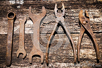 Iron rusty tools working on an old wooden Stock Photo