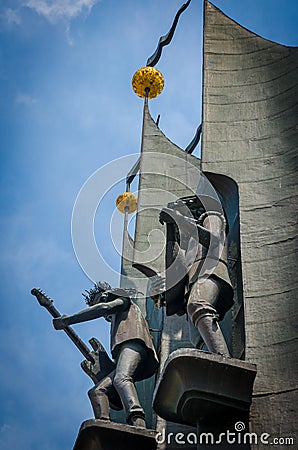 Iron sculpture of Bremen musicians playing stringed instruments. The photo captured them from below, against the backdrop of a cle Editorial Stock Photo