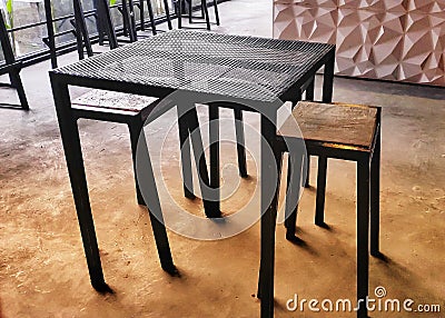 Iron tables and benches combined with wood on a cement floor. Stock Photo