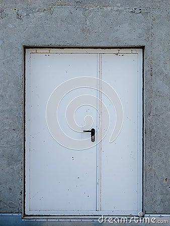 Iron white metal door in concrete wall Stock Photo