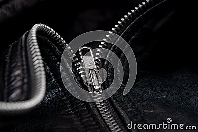 Iron zipper on a black leather jacket, needlework concept Stock Photo