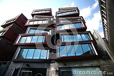 Modern rusty Ironbank with piled up boxes and glass windows. Mixed-used development on Karangahape Road, Auckland, New Zealand Stock Photo