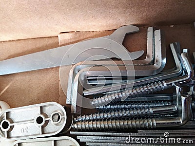 Ironmongery silver bronze iron stainless steel wrench tapping repair cardboard background macro photo Stock Photo