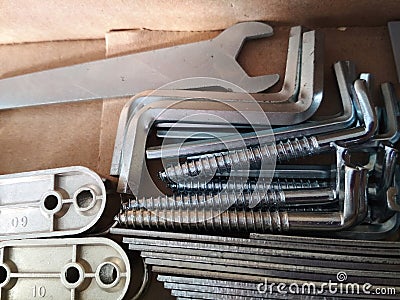 Ironmongery silver bronze iron stainless steel wrench tapping repair cardboard background macro photo Stock Photo