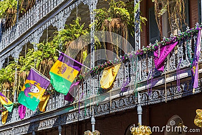 Ironwork galleries on the Streets of French Quarter decorated for Mardi Gras in New Orleans, Louisiana Stock Photo