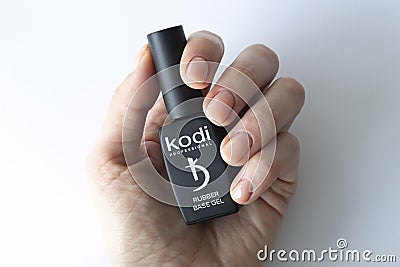 IRPEN, UKRAINE, JANUARY 20 20223, Base beige for Kodi Gel Lacquer in a woman's hands, Illustrative Editorial. Editorial Stock Photo