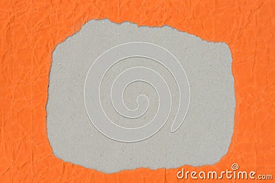 Irregular shape hole on piece on orange paper Stock Photo