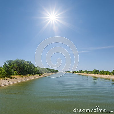 Irrigational channel at the sunny day Stock Photo