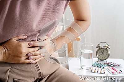 irritable bowel syndrome IBS concept with woman hand holding a stomachache Stock Photo