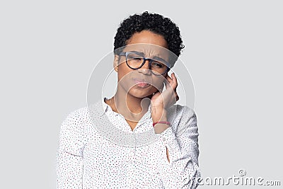 Irritated african american young woman suffering from strong earache. Stock Photo