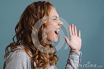 Irritated beautiful blonde girl gesturing an screaming aside Stock Photo