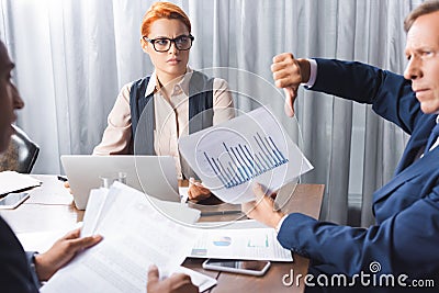 Irritated businesswoman looking at executive with Stock Photo