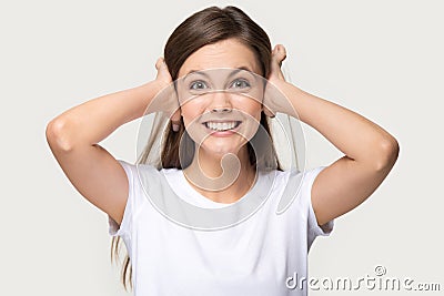 Irritated woman shut her ears with hands studio shot Stock Photo