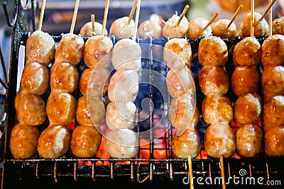 Isaan sausage being grilled on the traditional stove that be a part of street food in Thailand Stock Photo