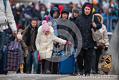Isaccea, Romania. 05 March, 2022. Refugee Ukrainians walk from Ukraine to Isaccea in Romania after crossing the border Editorial Stock Photo