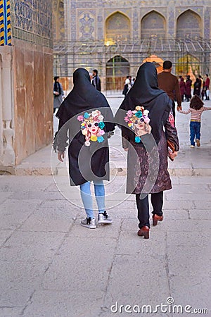 Two girls in hijab with the same pictures of portrait of girls in Isfahan. Iran Editorial Stock Photo