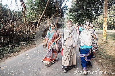 ISKCON Mayapur, West Bengal, India - Dec 15, 2019. international group of pilgrims in national Vaishnava clothes saris Editorial Stock Photo