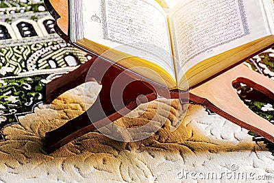 Islam holy book of Muslims, the Quran, is placed on a wooden sta Stock Photo