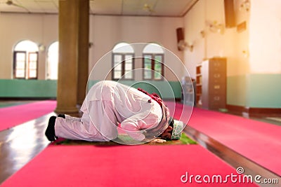 Islam muslim man in custom dress praying in mosque Stock Photo