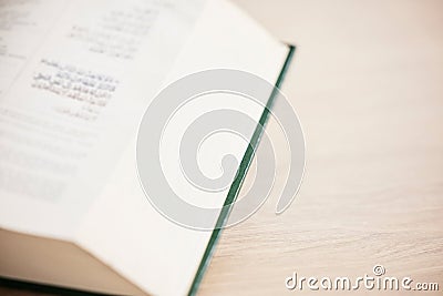 Islam, table and closeup of a Quran for reading, support and hope from a book in a house. Closeup, desk and an Arabic or Stock Photo