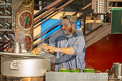 A man making a tea at tea stall in a winter morning Editorial Stock Photo