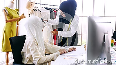 female merchandiser preparing clothing for customer at the office Stock Photo