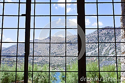 Island Spinalonga, A view of the beautiful world from the barred window of the prison cell Stock Photo