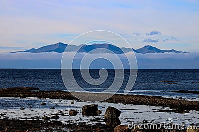 Isle of Arran Emerging from Low Cloud from Seamill Beach Scotland Stock Photo