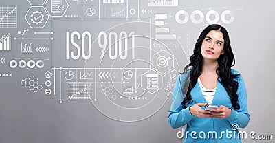 ISO 9001 concept with woman holding a smartphone Stock Photo