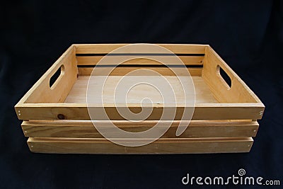 Isolate wooden box with grip handle on black background. Stock Photo