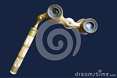 Isolated antique ornate brass opera glasses with handle on blue background Stock Photo