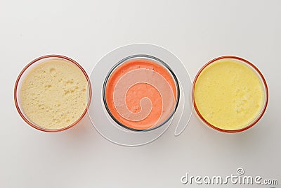 Isolated citrus juice. Three glasses with orange, grapefruit and lemon juice isolated on white background Stock Photo