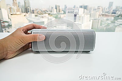 Isolated close up women hand with portable bluetooth speaker for music Stock Photo