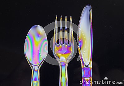 Isolated closeup shot of colorful holographic cutlery in front of a black background Stock Photo