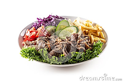 Isolated delicious Turkish veal kebab served on the white plate with fresh green letuce, juicy tomatoes, cabbage, cucumber and Stock Photo