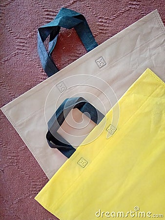 Isolated eco friendly Yellow black and brown bags with black handle Stock Photo