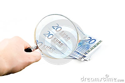 Isolated euro money under the reading glass kept i Stock Photo