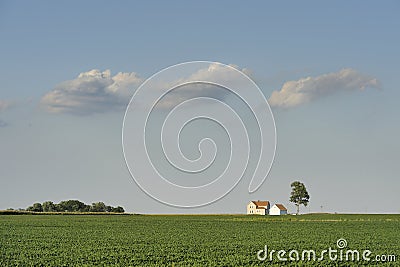 Isolated farm house under three clouds Stock Photo