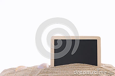Isolated framed black board and seashells in sand Stock Photo