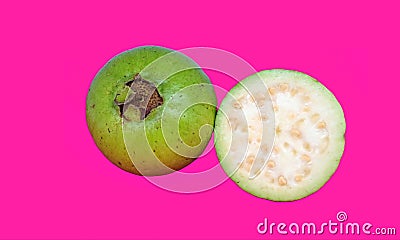 Isolated green guava with white flesh. One half whole fruit isolated on pink background with clipping path Stock Photo