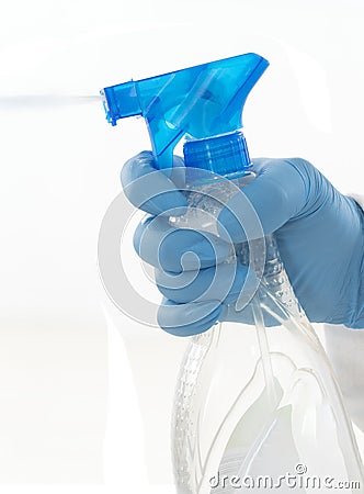 Isolated hand wearing cleaning glove holding a spray bottle Stock Photo