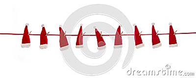 Isolated hanging red santa hats over white background. Stock Photo
