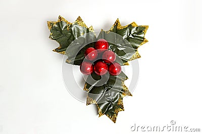 Isolated holly berry with leaves. Plastic, artificial Ilex berries on sprig. Stock Photo