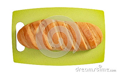 Isolated loaf of bread on green cutting board on white background. Stock Photo