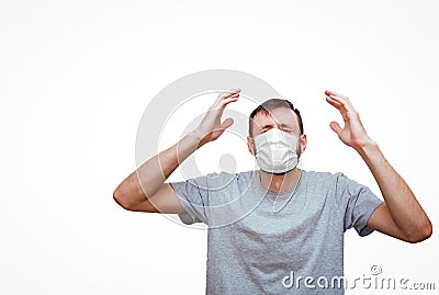 Isolated man on a white background with a medical mask on his face raised his hands up in panic and despair, Stock Photo