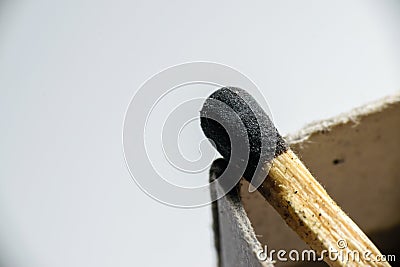 Isolated match stick kept over the edge of a matchbox in a white background. Space for text in left Stock Photo