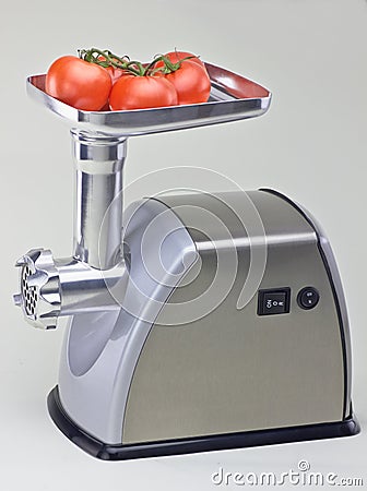 Isolated mincer with tomatoes Stock Photo